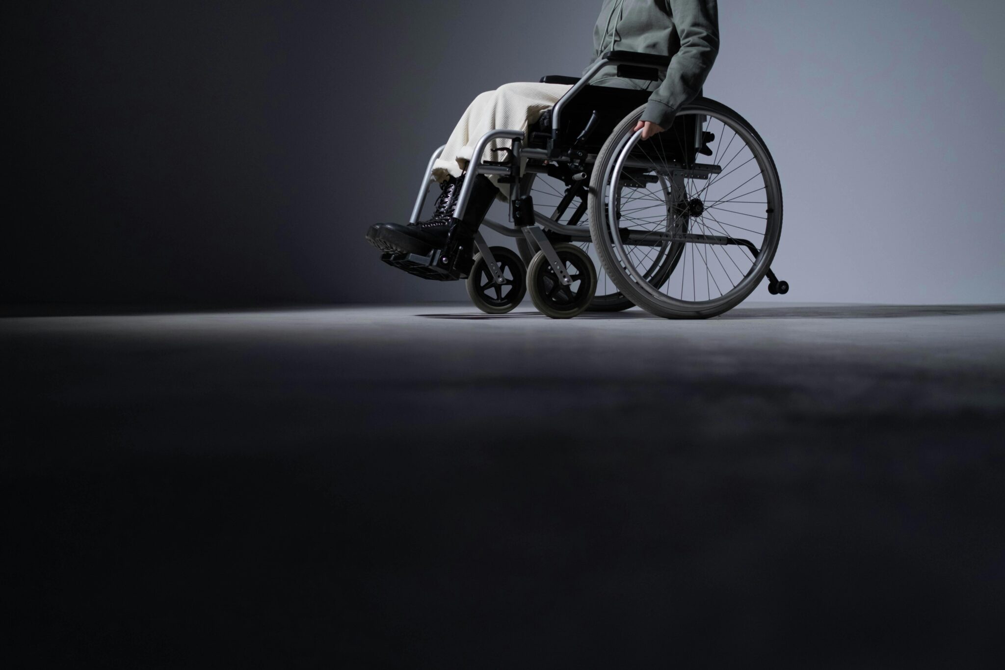 Studio shot of a person in a wheelchair with ample copy space, highlighting accessibility.